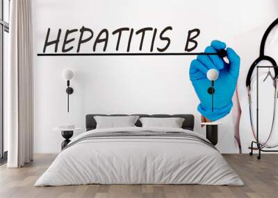 Doctor writing word HEPATITIS B Medical concept on white background Wall mural