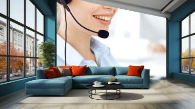 Female call operator is using computer and headset for consulting clients online, close-up. Group of diverse people working as customer service occupation Wall mural