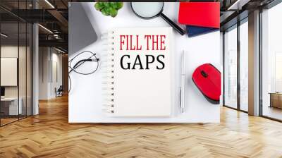 fill the gaps text on a notepad with laptop on the white background Wall mural