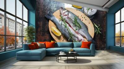 Fresh raw wild sea bass with herbs and spices on wooden cutting board top view. Healthy and organic food concept. Seafood concept. Wall mural