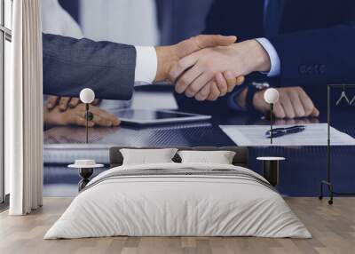 Handshake as successful negotiation ending, close-up. Unknown business people shaking hands after contract signing in modern office Wall mural