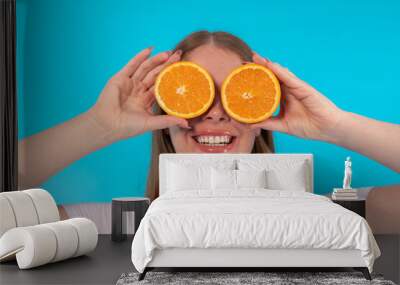 happy curvy smiling woman covering eyes with two pieces of orange  diet and healthy lifestyle Wall mural