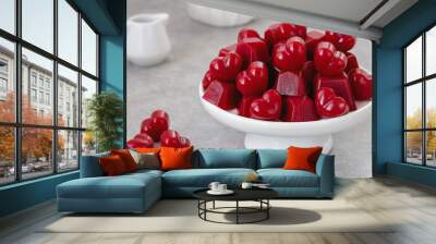 Homemade Gummy Candy. Red Heart shaped jelly sweets served on white serving stand with syrup pitcher on background.  Wall mural