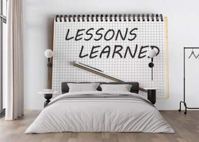 Lessons Learned text written on a notebook with pen Wall mural