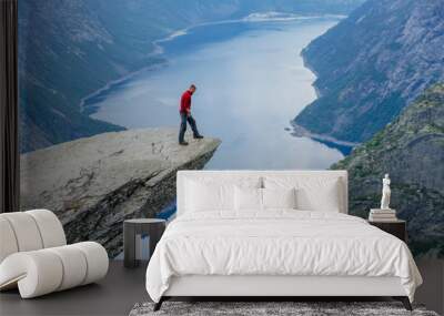 Man in blue sportswear standing on trolltunga in Norway. Wall mural