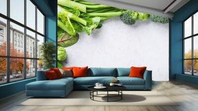 Background with assorted green vegetables, salad, broccoli, cucumber, peas and Brussels sprouts on light gray stone table top. Healthy food concept with copy space. Wall mural