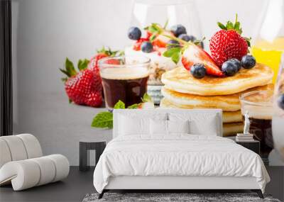 Breakfast composition with fresh pancakes and berries on light gray concrete background. Healthy food concept with copy space. Banner. Wall mural