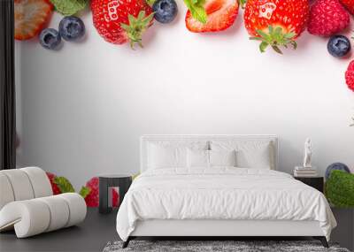 Frame banner made of fresh strawberry, raspberry and blueberry on white background, top view, flat lay. Creative food concept with copy space Wall mural