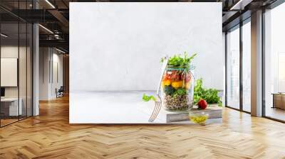 Homemade salad in glass jar with quinoa and vegetables. Healthy food, diet, detox, clean eating and vegetarian concept with copy space. Wall mural