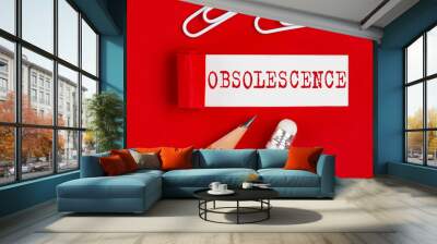 OBSOLESCENCE message written on torn red paper with pencils and clips, business Wall mural