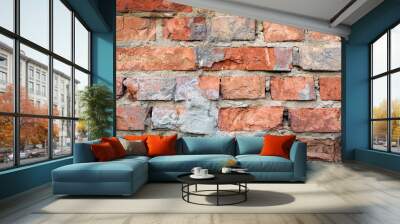 Old Brick Wall with Crumbling Mortar. A detailed view of an old brick wall with visible signs of wear and crumbling mortar. Wall mural