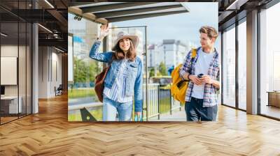 People student traveling concept. Couple traveling together standing at bus station, Waiting for transport. High Resolution Wall mural