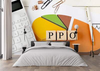 PPO health insurance concept with pie chart, wooden blocks, calculator, and office supplies Wall mural