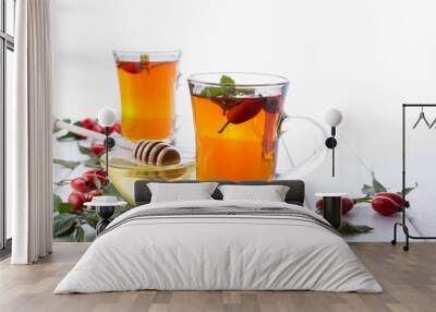 Rose hip tea in transparent cup with honey and fresh berries. Vitamin C drink on white  background. Wall mural