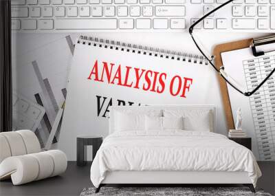 Text ANALYSIS OF VARIANCE on Office desk table with keyboard, notepad and analysis chart on white background. Wall mural