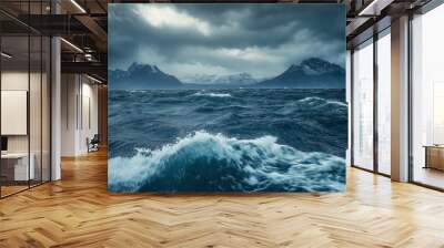 The ocean is rough and choppy, with waves crashing against the shore. The sky is dark and cloudy, creating a moody atmosphere Wall mural