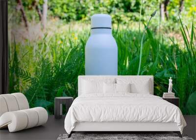 Thermo stainless bottle with water foe summer hot day on the nature. Wall mural