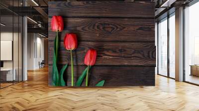 Red beautiful tulips on old brown wooden background with space for text. Spring concept. Texture surface for design. Close-up. Postcard template. selective focus Wall mural