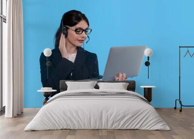 Woman in Headset Joins Virtual Meeting Against Bright Blue Backdrop Wall mural