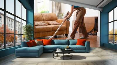 woman with vacuum cleaner cleaning floor  at home Wall mural