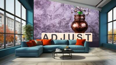 Word ADJUST made with wood building blocks on a gray back ground Wall mural