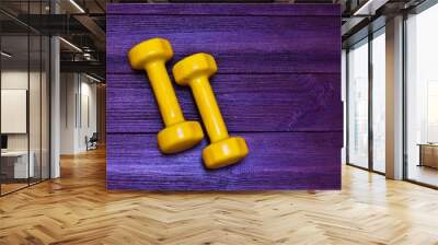 Yellow sports dumbbells on a wooden background. place for text. flat lay. concept of sport, fitness. Wall mural