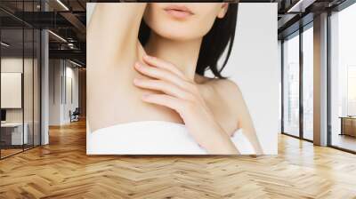 concept of skin care and cosmetology. young thin woman takes care of the skin of the body, touches the skin on the neck and shoulders, after moisturizing and rejuvenation procedures and hair removal Wall mural