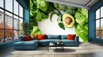 Avocado, salad, broccoli, spinach and pepper on white background. Healthy food concept with fresh assorted green vegetables. Copy space Wall mural