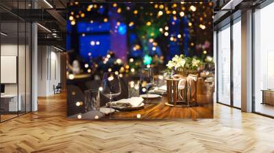 Blurred party background with served table with bouquet of flowers and people sitting at restaurant, bar or night club with colorful lights bokeh. Wall mural