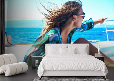 Young happy woman in sunglasses feels fun on the luxury sail boat yacht catamaran in turquoise sea in summer holidays, Greece. Wall mural