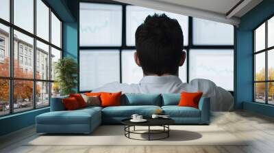 A businessman analyzing stock charts on multiple computer screens, modern office setting, calm and focused expression, financial growth and strategy. Wall mural