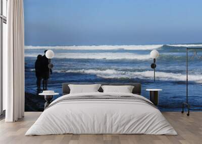 An unrecognizable couple walking on the beach at Sunset Cliffs in San Diego, California  Wall mural