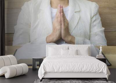  a woman praying behind the holy bible  on wooden table Wall mural