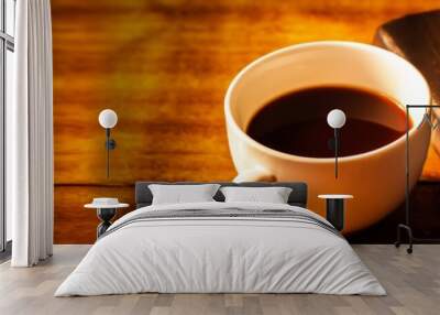 Close up of a cup of coffee and holy bible  on wooden table, Bokeh light effected for web page cover Wall mural