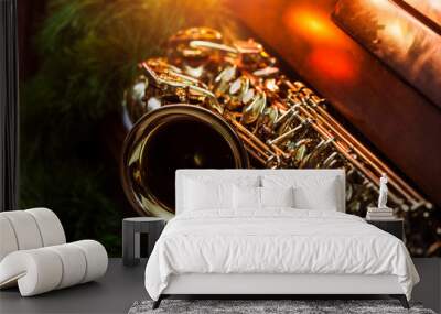 close up of alto saxophone  on the Piano Keys with Christmas tree and decoration light, in the night of Christmas season, Christmas background Wall mural