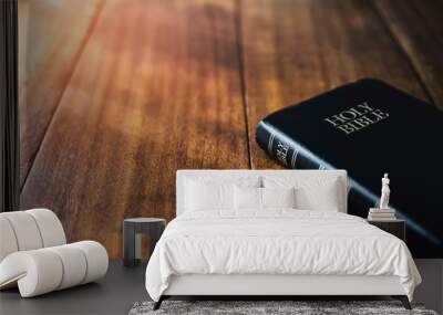 holy bible on wooden table background with soft morning sun light Wall mural