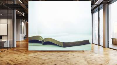 open bible on table with window light, copy space Wall mural