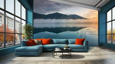 The water reflection of the sunrise breathtaking beauty nature scenery landscape with mountain mist in Khuean Phluang Reservoir nearby Khao Khitchakut National Park, Chanthaburi, Thailand
 Wall mural