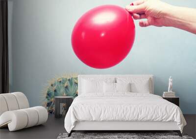 Cactus and red balloon, close up Wall mural