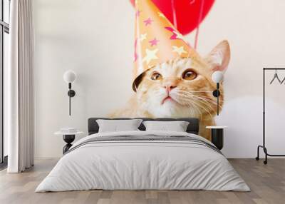 Red cat in a festive cap against the background of balloons. Birthday of a cat. Wall mural