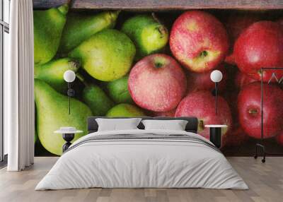 Ripe green pears and red apples in a wooden box with grunge texture, top view. Autumn harvest of pears Wall mural