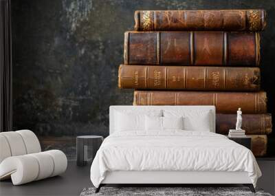 stack of antique leather bound books against a dark background Wall mural