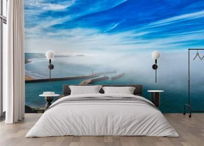 Aerial view of coastal pier with lighthouse and fog in Whitby, North Yorkshire Wall mural