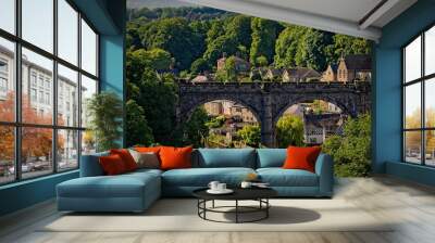 Historic stone bridge over river in lush green town in Knaresborough Wall mural