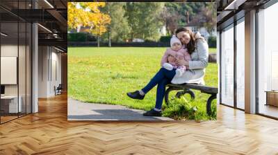 Mother and Baby Enjoying Autumn Day in the Park Wall mural