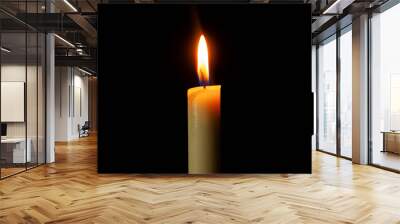 Candle light burning brightly in the black background, blank and wide background for copy space. Wall mural