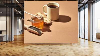 Minimalistic poster - composition with tea, lemon, honey and ginger on a brown background. Healing tea for colds. Wall mural