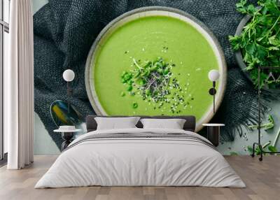 Vegetarian bowl with green cream soup of broccoli and green peas on a gray cloth. Top view food flat lay Wall mural