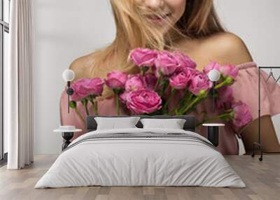 Blonde girl with a bouquet of roses flowers isolated on a gray background, Romantic Valentine's Day girl Wall mural