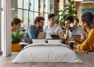 A diverse team engaged in a meeting around a table in a well-lit modern office, suggesting a collaborative work environment ideal for corporate settings. Wall mural